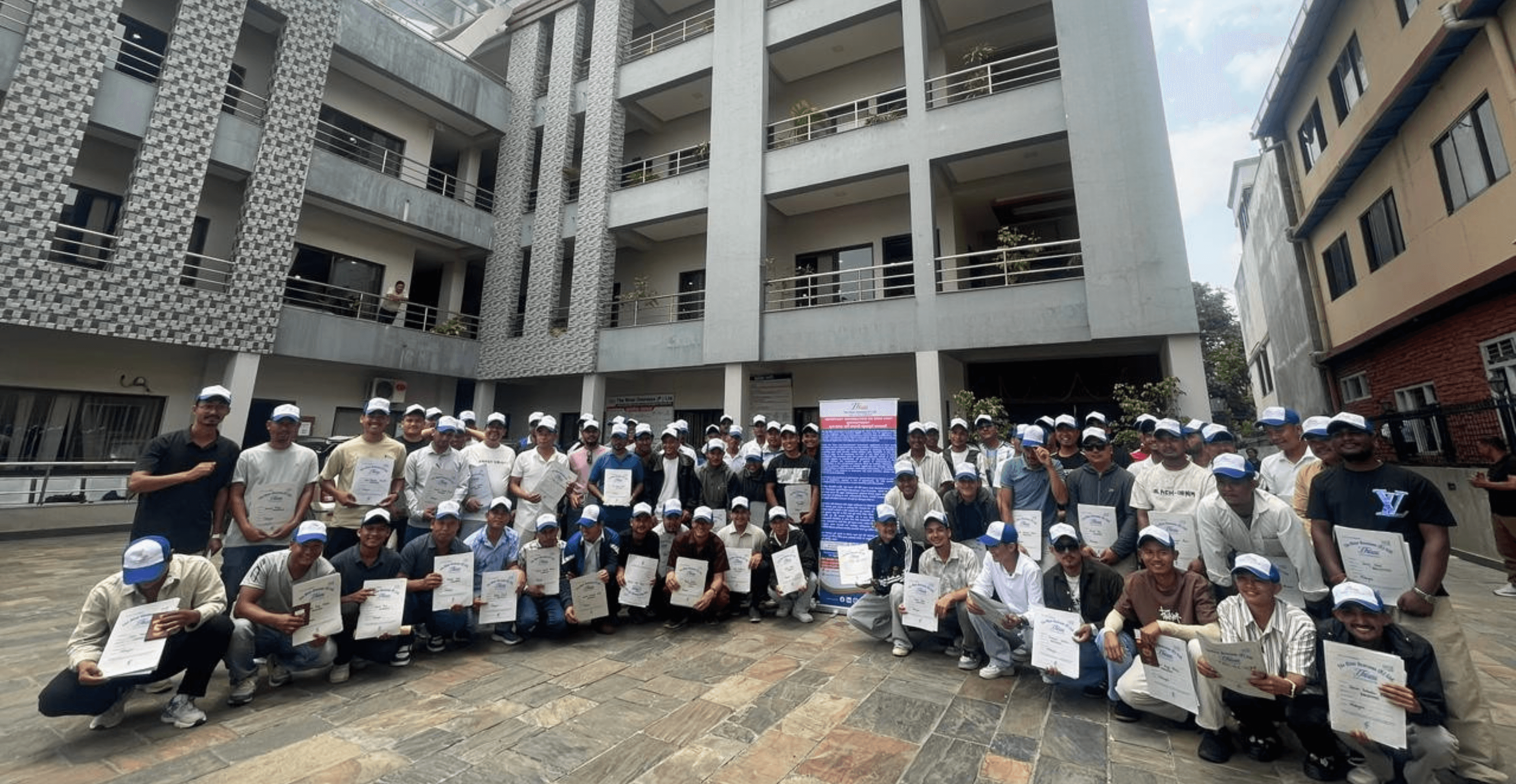 The River Overseas team at a training completion ceremony outside the company office in Kathmandu